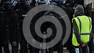 Yellow vests - Gilets jaunes protests - Protester standing alone in front of riot police