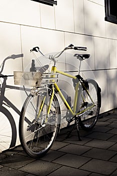 Yellow vintage bicycle parked on the street on a sunny day