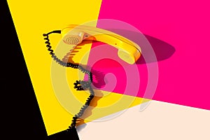 Retro vintage phone handset yellow pink red purple plastic orange disko background old style shadow 90 black