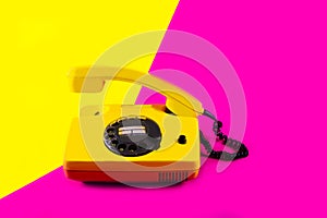 Retro vintage phone handset yellow pink red purple plastic orange disko background old style shadow 90 answer reply raised