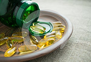 Yellow vitamin D3 cholecalciferol gelatine capsules and green