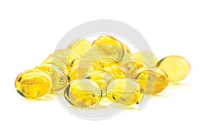 Multiple yellow fish oil, omega 3, vitamin D capsules, healthy diet, heart health concept, large detailed isolated macro closeup