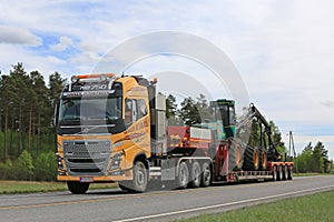 Yellow Volvo FH Transports Forestry Equipment