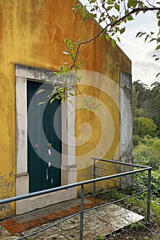 Yellow wall and blue door in a small village, Tuscany, Italy