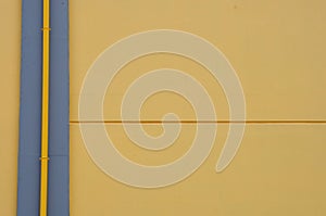 Yellow wall and drain pipe background