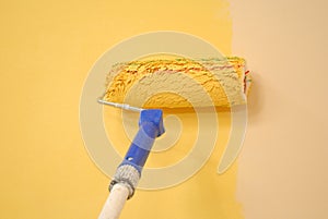 Yellow wall painting roller