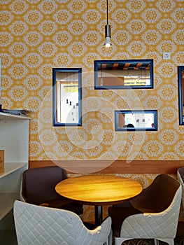 Yellow wallpapers and mirrors in cafe interior