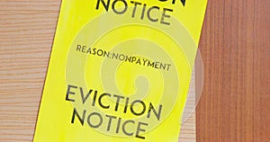 Yellow warning Eviction Notice of nonpayment hangs on door