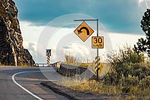 Yellow warning road signs on roadside