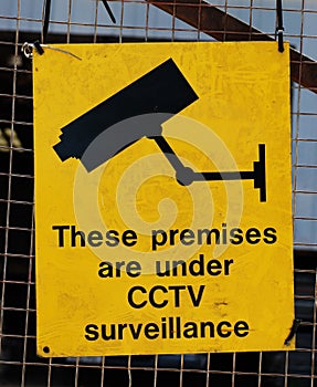 Yellow warning sign for CCTV surveillance