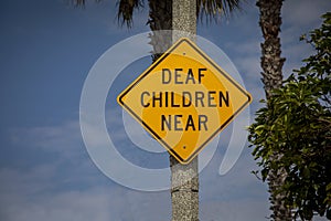 Yellow warning sign stating Deaf Children Near