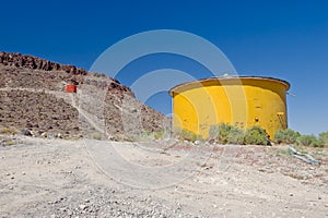 Yellow water tank in desert