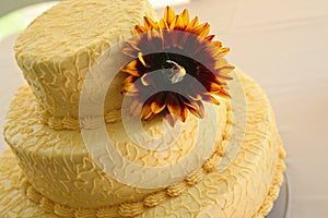 Yellow wedding cake with big flower