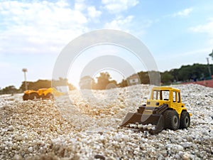 Yellow wheel Loader excavator construction machinery equipment toy holding the sand, children learning object