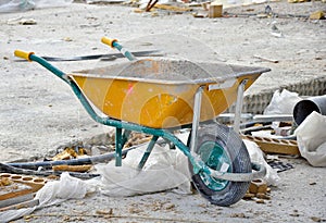 Yellow wheelbarrow on a construction site