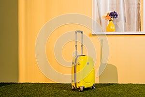 yellow wheeled bag on floor at home,