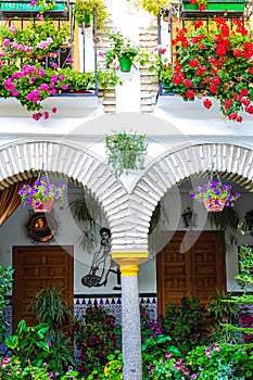 Yellow and white brick arches at the Festival of Patios in Cordoba