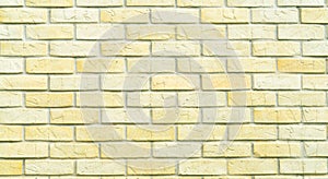 Yellow and white brick wall texture background with space for text. Old bricks wallpaper. Home interior decoration. Architecture