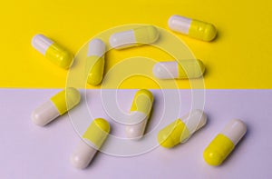 Yellow-white capsules of celibacy on a yellow-white background. Medical background.