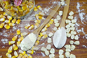 Yellow and white corn and flour in spoons