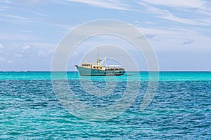 Yellow and White Fishing Boat in Aqua Water