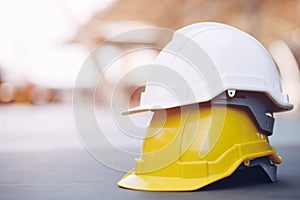 Yellow and white hard safety wear helmet hat in the project at construction site