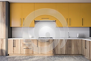 Yellow and white kitchen interior with countertops