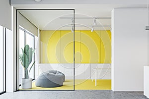 Yellow and white office waiting room with pouffes