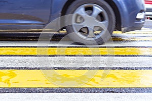 Yellow white pedestrian crossing with car
