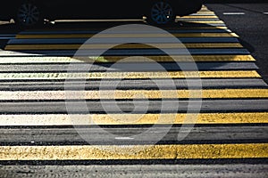 Yellow and white pedestrian crossing, zebra, car