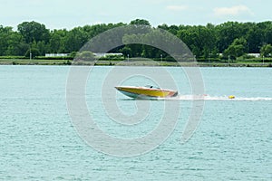 yellow and white power boat on st clair river ontario