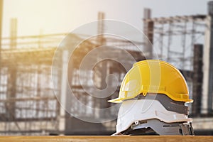 yellow with white safety helmet on table in construction