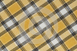 Yellow white tartan texture background. shirt fabric with a checkered pattern. factory material