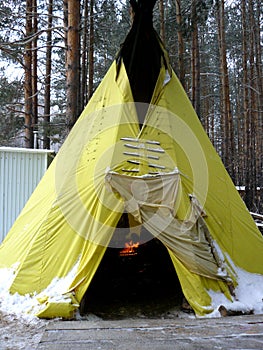 Yellow Wigwam in the winter forest photo