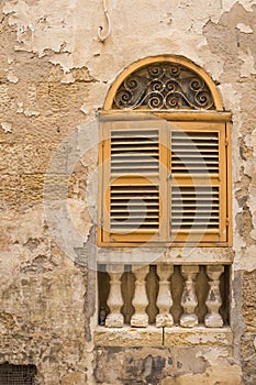 Yellow window with an arch and shutter, island Malta