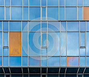 Yellow window in blue glass building