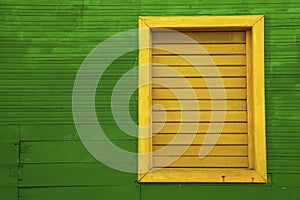 Yellow window on green house