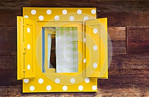 Yellow window on wooden house