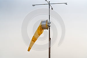 Yellow Windsock Against A Bright Sky Background
