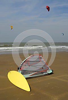Yellow windsurf lying on the beach