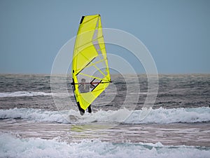Yellow Windsurf Riding the Waves