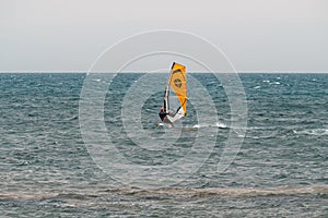 Yellow windsurf  Riding the Waves in a Choppy Sea