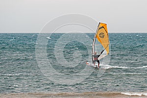 Yellow windsurf  Riding the Waves in a Choppy Sea