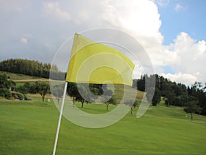 Yellow Windy Flag at Golf Course on Mountain