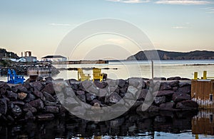 Yellow wooden Adirondack chairs overlooking the ocean