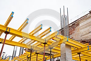 Yellow wooden beams for monolithic building construction