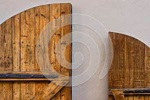 Yellow wooden door against a white wall