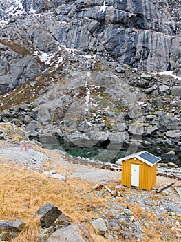 Yellow wooden fisherman shed in Nusfjord, Flakstadoya, Lofoten islands, Nordland, Norway