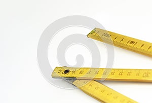 A yellow wooden folding ruler isolated on a white background