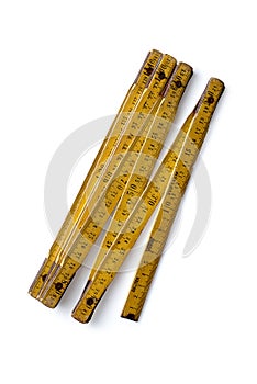 Yellow wooden folding ruler on a white background